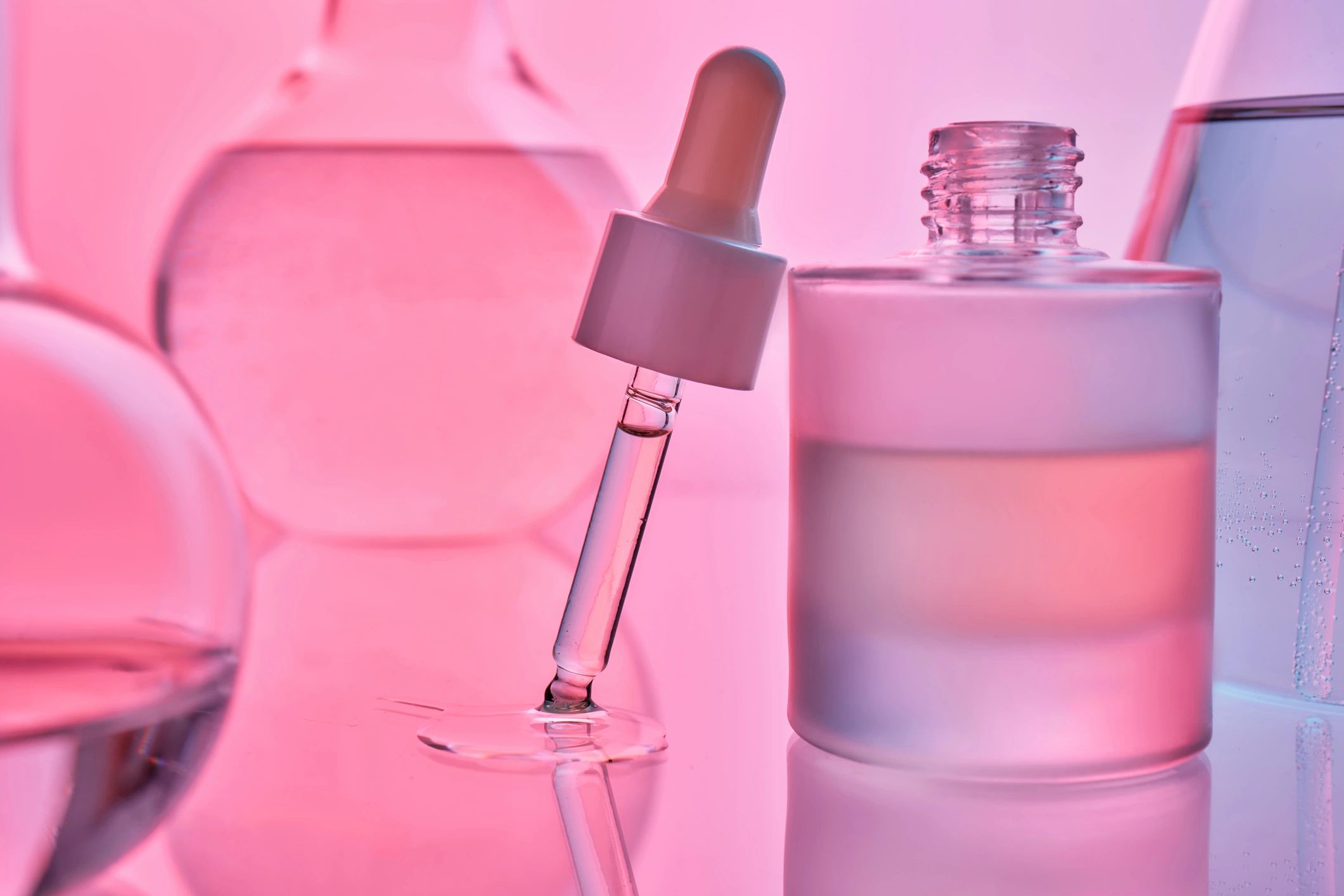 Luxury fragrance-inspired beauty product flatlay in pink tones